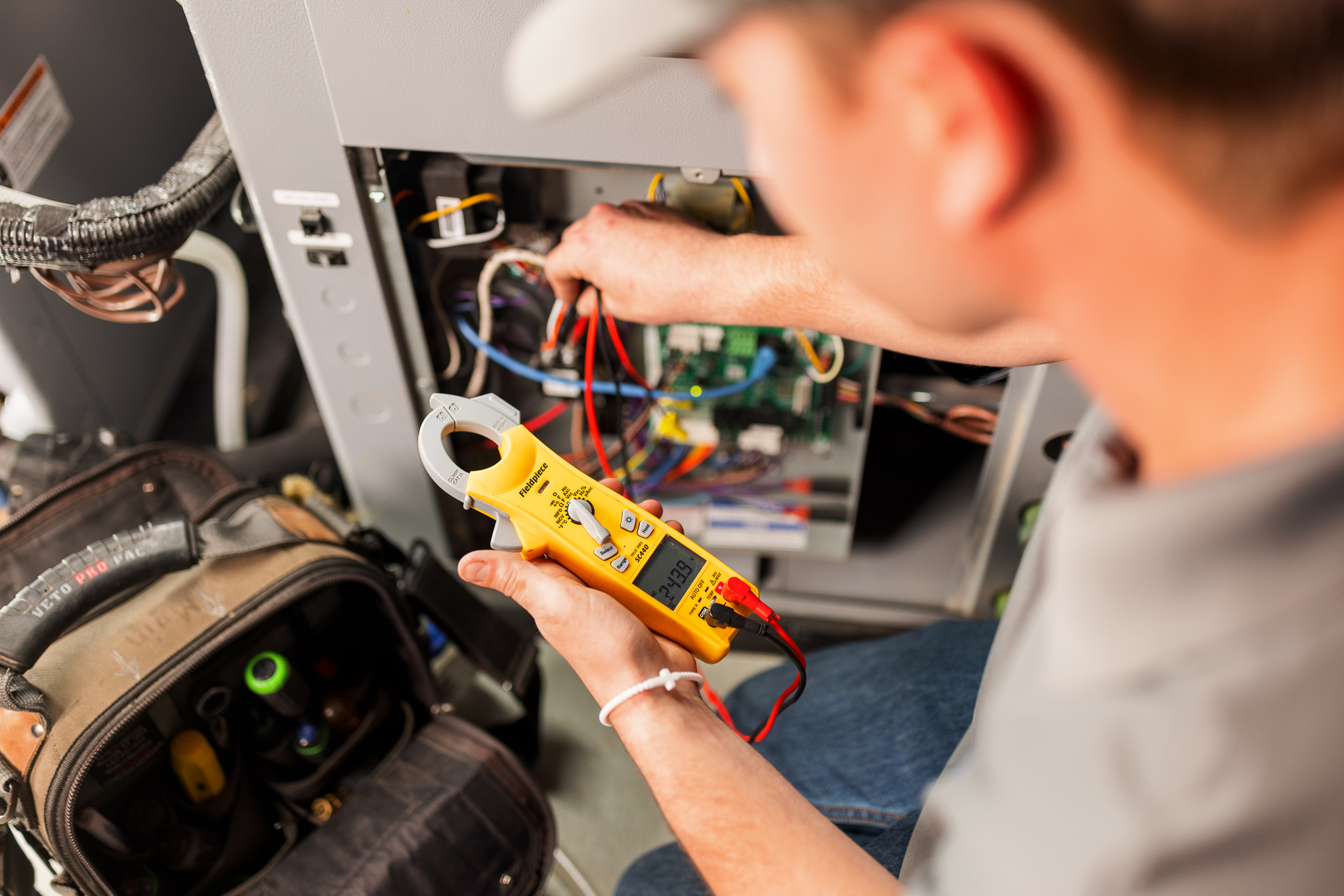 An ACTION technician fixing a furnace on a home service call. 