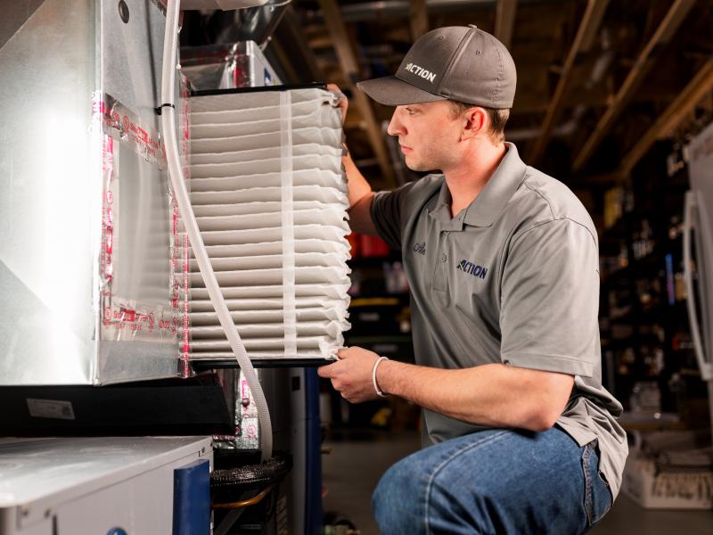 Technician replacing air filter