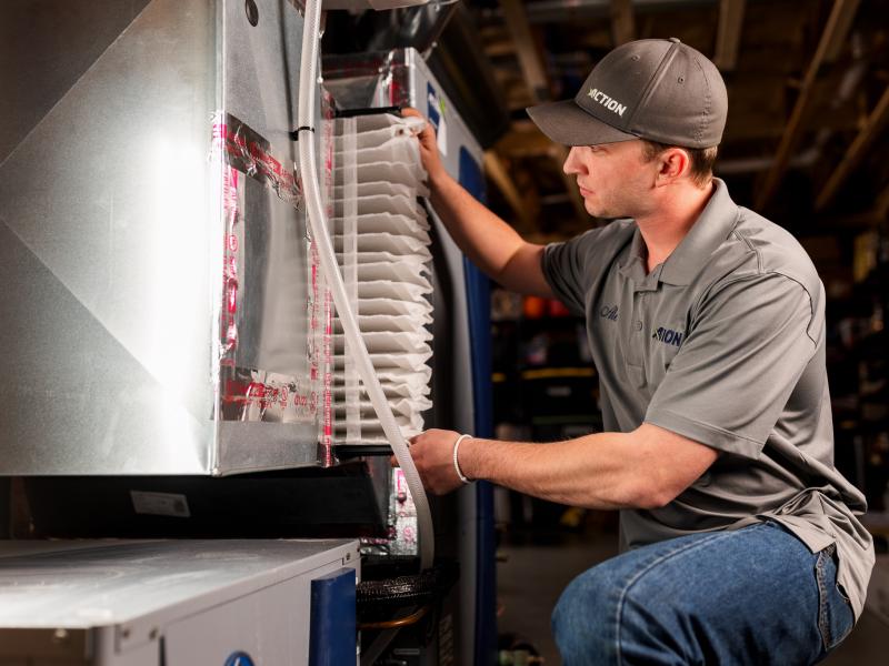 Action technician installing air filter